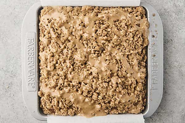 baked pumpkin crumb cake with maple glaze in a pan