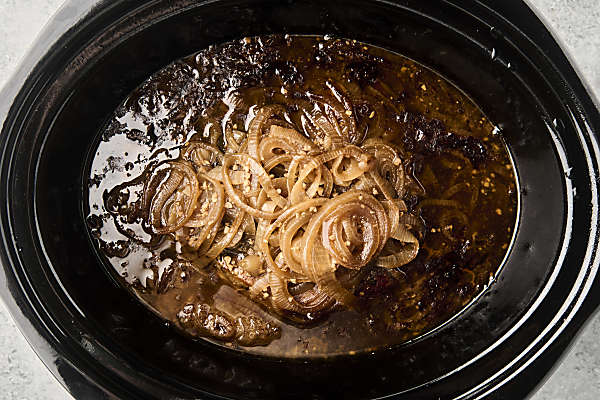 cooked roast with onions in the crockpot
