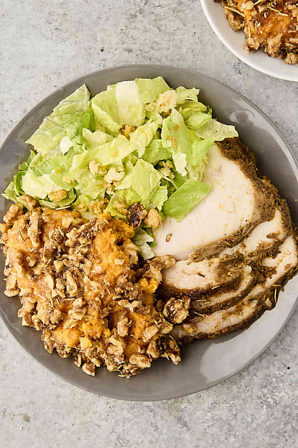savory brown butter sweet potato casserole with rosemary walnut topping on a plate