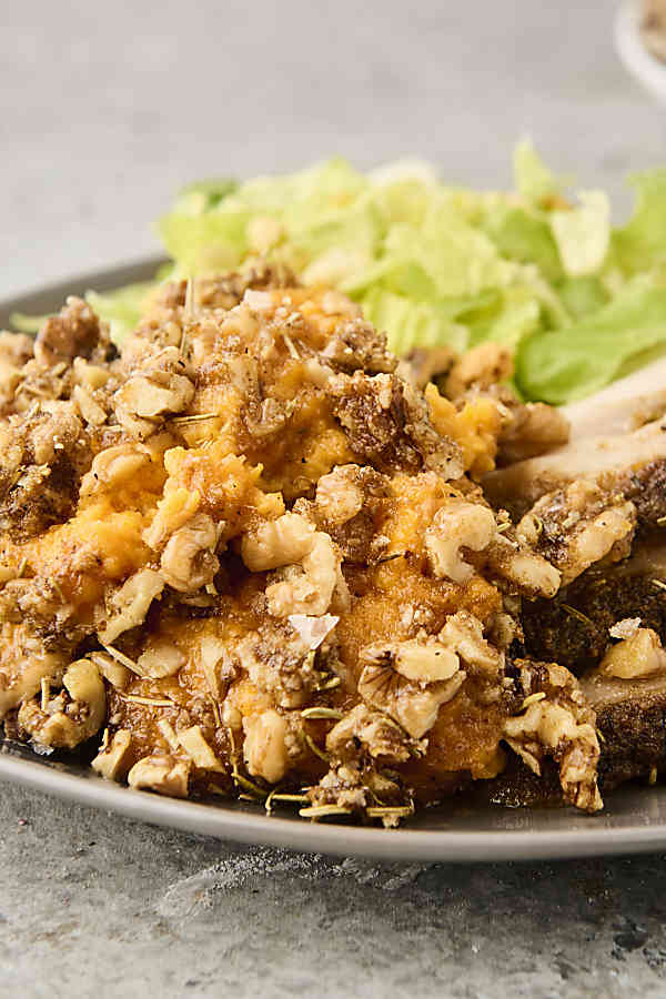 savory brown butter sweet potato casserole on a plate with turkey and salad