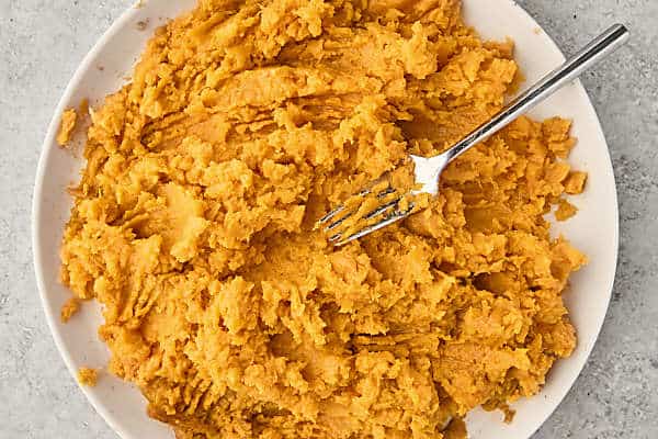 mashing sweet potatoes