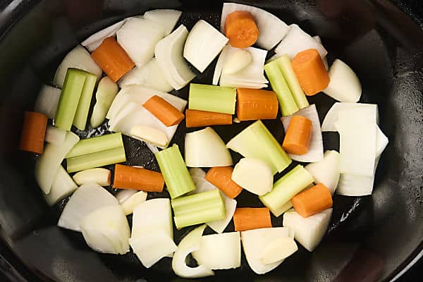 aromatics (onion, carrot, celery, garlic) in slow cooker