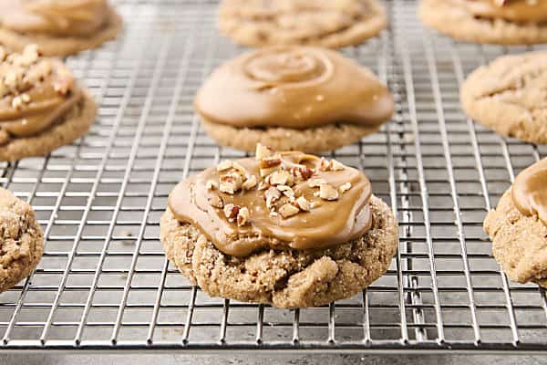 topping maple sugar cookies with optional chopped pecans