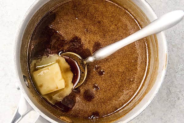 whisking butter, maple extract, and salt into the boiled cream and sugar