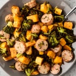 sheet pan chicken sausage with broccoli and sweet potato on a plate
