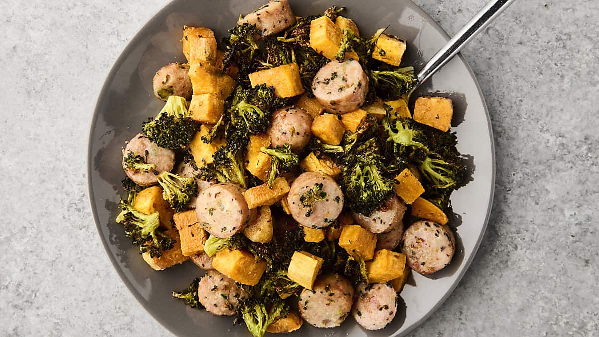 sheet pan chicken sausage with broccoli and sweet potato on a plate