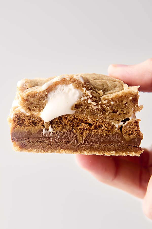 holding a smores bar in hand