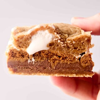 holding a biscoff cookie butter smores bar in hand