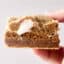 holding a biscoff cookie butter smores bar in hand