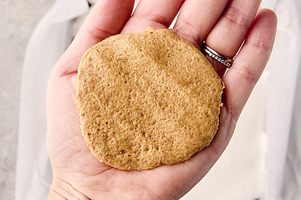 flatten cookie dough chunk in hand to create top layer of crust