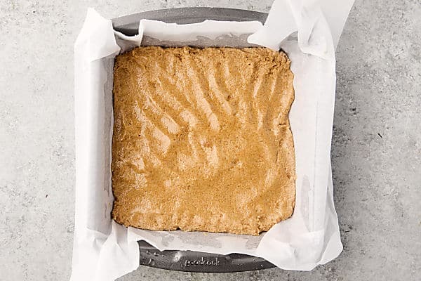 half of the cookie dough in a prepared pan pressed down to make a crust
