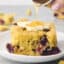 drizzling butter topped blueberry cornbread with honey