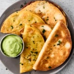 crispy black bean tacos on a plate with dipping sauce