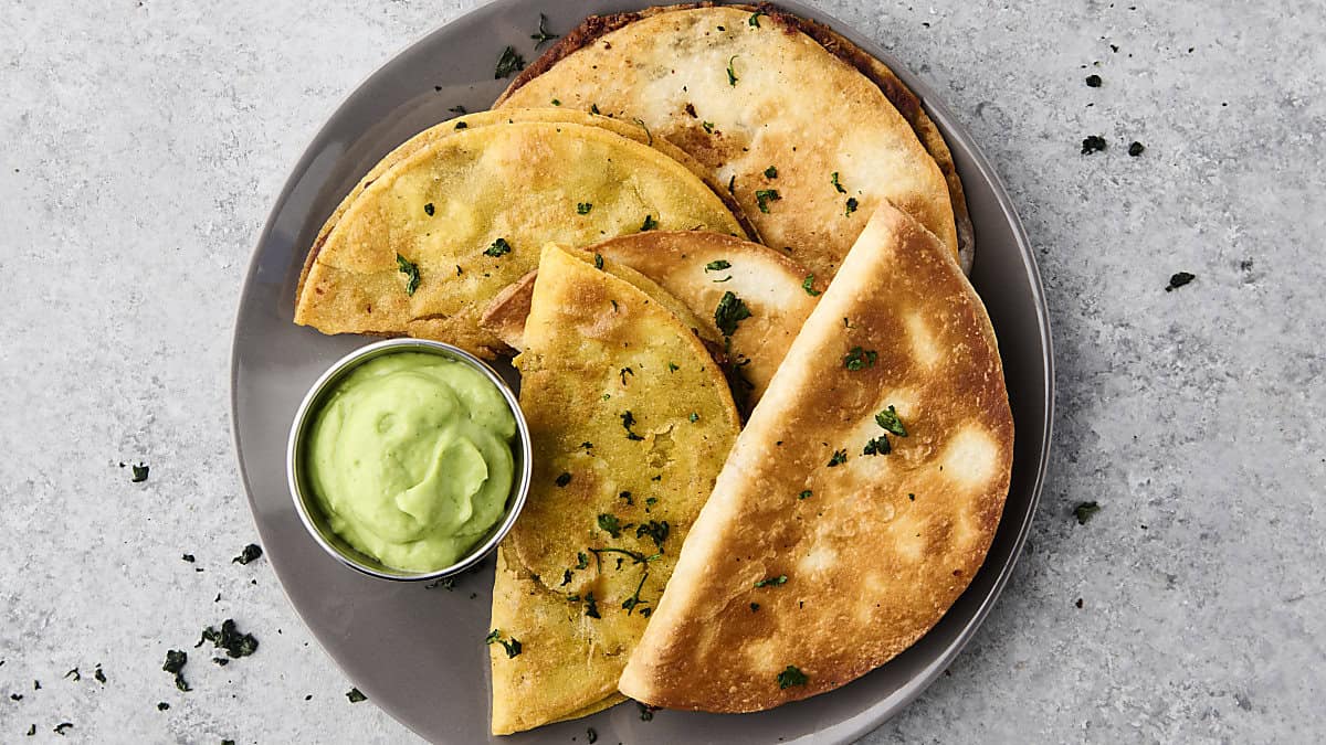 crispy black bean tacos on a plate with dipping sauce