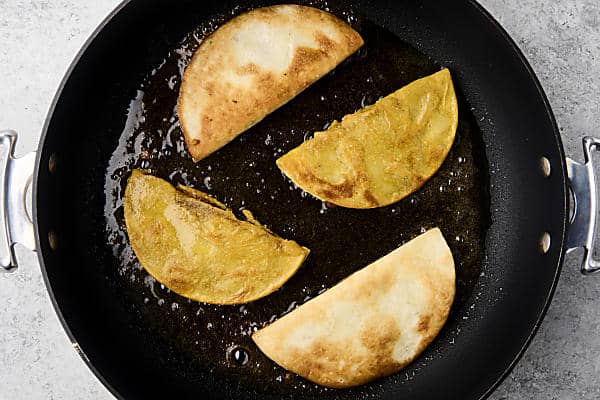 pan frying black bean tacos in oil