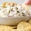 dipping a kettle chip into blue cheese and olive dip