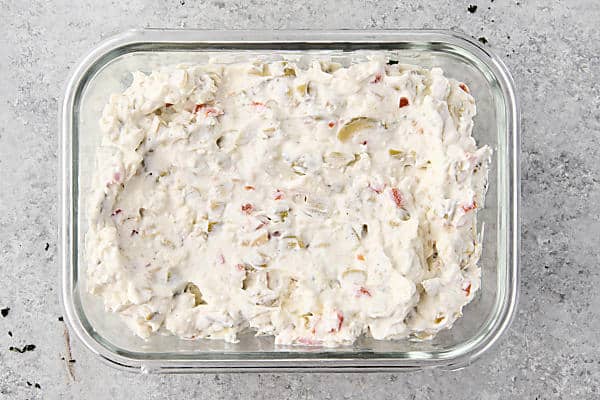 martini dip placed in glass tupperware to chill in the fridge