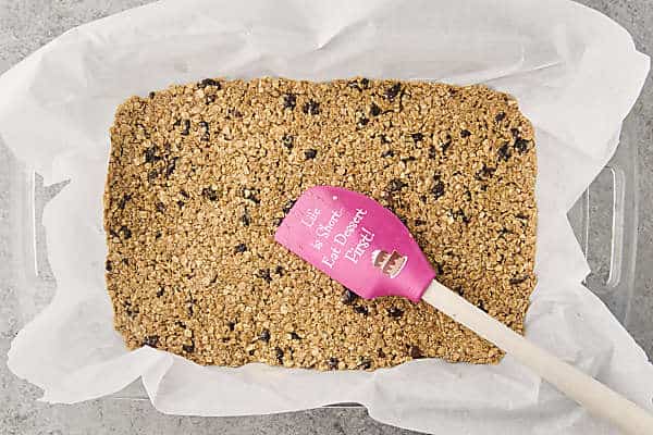 pressing mixture firmly into a prepared pan