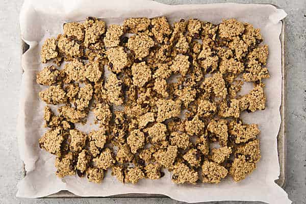 oatmeal cookie granola clusters cooling on a pan