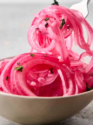 quick pickled red onions on a fork