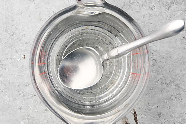 water, vinegar, sugar, and salt dissolved in a bowl