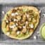 roasted cauliflower and chickpea pita on a tray with avocado sauce
