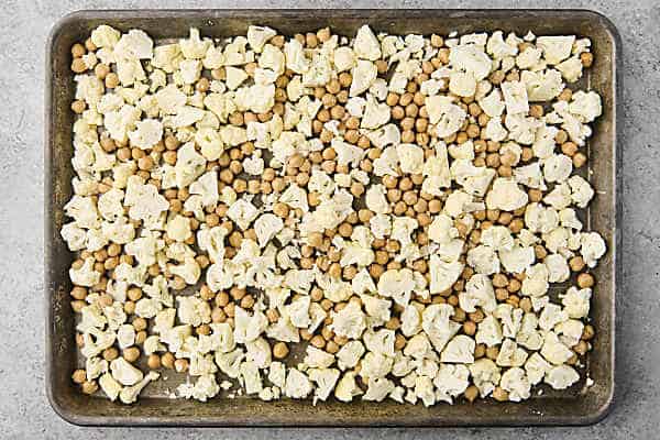 cauliflower and chickpeas on a rimmed baking sheet