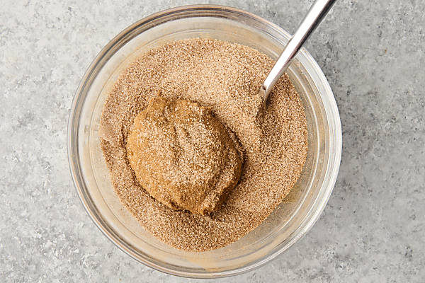 dunking cookie in optional cinnamon sugar