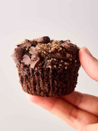 holding a double chocolate pumpkin spice muffin