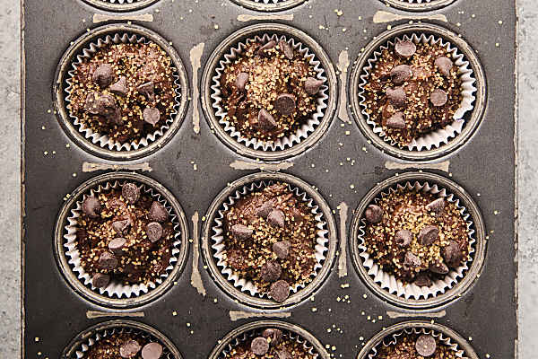 spooning batter into muffin tin