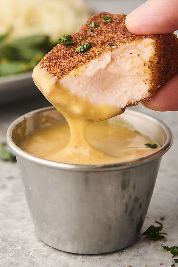 dunking salmon into honey mustard