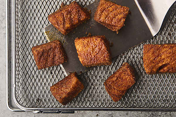 cooked salmon on an air fryer basket
